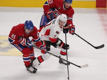 Ottawa Senators' Kyle Turris is flanked by Montreal Canadiens' Lars Eller and Jacob De La Rose during first- period action in Montreal on Wednesday, April 15, 2015.