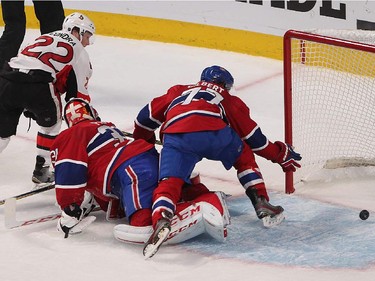 Montreal Canadiens' Tom Gilbert and goalie Carey Price scramble with Ottawa Senators' Erik Condra on the prowl during third- period action in Montreal on Wednesday, April 15, 2015.