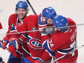 The Canadiens' Alex Galchenyuk celebrates after scoring overtime goal with teammates Alexei Emelin (74) and David Desharnais during Game 2 of Eastern Conference quarterfinal series against the Ottawa Senators on April 17, 2015 at the Bell Centre.