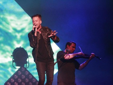 Ryan Tedder, right, lead singer of OneRepublic and Zach Filkins at the violin, perform during a show at the Bell Centre on Monday April 20, 2015.