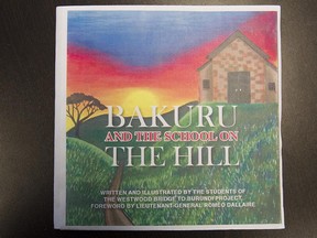 The mockup of a book published by students of Westwood High School, in Hudson on Monday April 20, 2015. With teacher Nancy Koluzs, students at Westwood High School have published a book telling the tale of a little girl who discovers a school on a hill, just like the school these kids have build in the town of Rwoga.
