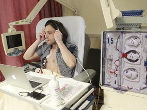 Philippe Ouaknine, 34, puts on his headphones to work on his computer while he gets his dialysis treatment at the Livingston Pavilion of the Montreal General Hospital. "How could they not include us in the new hospital?" he asks.