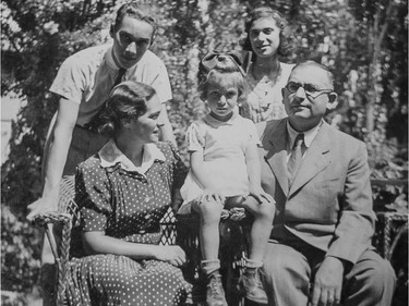 A 1940s photograph showing Évike Weinberger (child at centre) and her parents Gusztáv (sitting right) and Mancika (sitting left) in Hungary. (Courtesy of Elaine Kalman Naves)