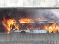 A bus is engulfed in flames on the Ville-Marie expressway in Montreal on April 23, 2015. No injuries were reported.