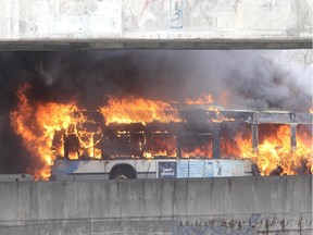 A bus is engulfed in flames on the Ville-Marie expressway in Montreal on April 23, 2015. No injuries were reported.