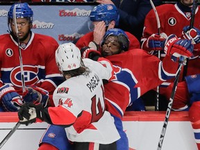 Canadiens defenceman P.K. Subban, rear, is pushed into the the players bench by Ottawa Senators center Jean-Gabriel Pageau, front, during the third period of game five of their NHL Eastern Conference quarter-final match at the Bell Centre in Montreal on Friday, April 24, 2015.