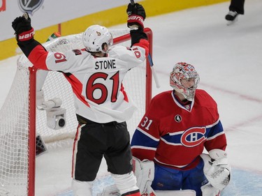 Ottawa Senators right wing Mark Stone, left, celebrates a goal by teammat Erik Karlsson, not pictured, as Montreal Canadiens goalie Carey Price, right, looks on during the second period of game five of their NHL Eastern Conference quarter-final match at the Bell Centre in Montreal on Friday, April 24, 2015. (Dario Ayala / Montreal Gazette)