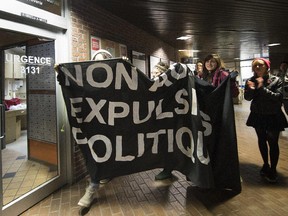 Protesters walk through the halls of UQAM on Friday in a demonstration against nine possible student expulsions.