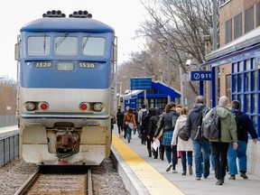 Passengers arrive to board the train heading to Saint-Jerôme at the Parc Station of the Saint-Jerôme line of the AMT in Montreal on Monday, April 27, 2015.