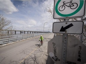 A cyclist crosses the St Lawrence river on the ice bridge onto Nuns Island a suburb of Montreal, on Tuesday, April 28, 2015.