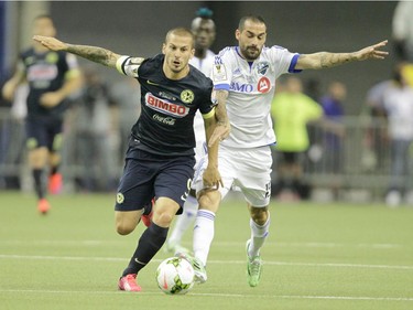 Andres Romero (right) of the Montreal Impact battles for a ball with Dario Benedetto of Club America in the first half of the final game of CONCACAF Champions League final between Montreal Impact and Club America from Mexico City in Montreal at the Olympic Stadium Wednesday, April 29, 2015.