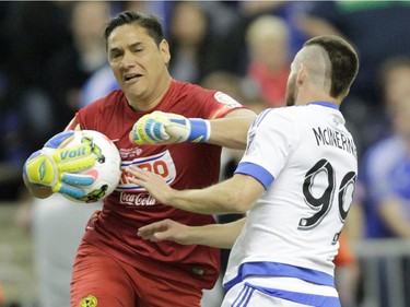 Club America goal keeper Moisés Muñoz protects himself from a charging Jack McInerney of the Montreal Impact in the second half  of the final game of CONCACAF Champions League final between Montreal Impact and Club America from Mexico City in Montreal at the Olympic Stadium Wednesday, April 29, 2015.