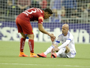 Club America goal keeper Moisés Muñoz consoles Laurent Ciman of the Montreal Impact at the end of the final game of CONCACAF Champions League final between Montreal Impact and Club America from Mexico City in Montreal at the Olympic Stadium Wednesday, April 29, 2015. Club America won.