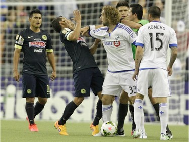 Marco Donadel of the Montreal Impact shoves Miguel Samudio in the face in a feisty first half of the final game of CONCACAF Champions League final between Montreal Impact and Club America from Mexico City, in Montreal Wednesday, April 29, 2015.