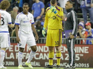 Montreal Impact goalie Kristian Nicht (in yellow) shows his disappointment at the end of the final game of CONCACAF Champions League final between Montreal Impact and Club America from Mexico City in Montreal at the Olympic Stadium Wednesday, April 29, 2015.