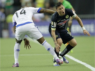 Nigel Reo-Coker (left) of the Montreal Impact battles for a ball with Rubens Sambueza of Club America in the first half of the final game of CONCACAF Champions League final between Montreal Impact and Club America from Mexico City in Montreal at the Olympic Stadium Wednesday, April 29, 2015.