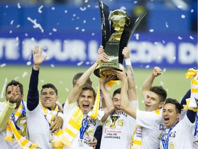 Players from Club America hoist the championship trophy at the end of the final game of CONCACAF Champions League final between Montreal Impact and Club America from Mexico City in Montreal at the Olympic Stadium Wednesday, April 29, 2015.