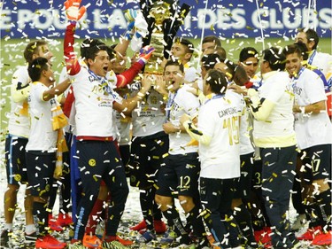 Players from Club America hoist the championship trophy at the end of the final game of CONCACAF Champions League final between Montreal Impact and Club America from Mexico City in Montreal at the Olympic Stadium Wednesday, April 29, 2015.