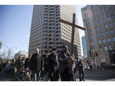 Philippe Djiele carries the crucifix at the head of the Way of the Cross procession in Montreal on Friday, April 3, 2015. Christians all over the globe were marking the day Jesus died and was placed in the tomb from which he would rise again on Easter Sunday.
