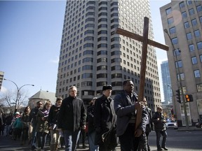 Philippe Djiele carries the crucifix at the head of the Way of the Cross procession in Montreal.