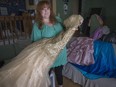 Lou-Anne Hood holds one of the dresses that has been donated. She has started to offer a service from her home in Rigaud to help teenagers who cannot afford formal attire for their high school prom.