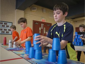 Students from Heritage Elementary School, in Huntingdon, Benjamin French, left, Quinn Burrows Andy Robidoux and Marus Legros, in the back, practice for the 2015 World Sport Stacking Championships in Montreal this weekend.  (Peter McCabe / MONTREAL GAZETTE)