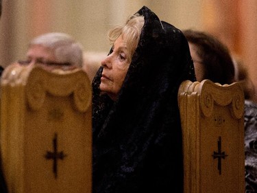Lise Dagenais listens to a special service at Mary Queen of the World Basilica for Archbishop Jean-Claude Turcotte in Montreal on Wednesday April 8, 2015. Turcotte died Tuesday night at age 78.