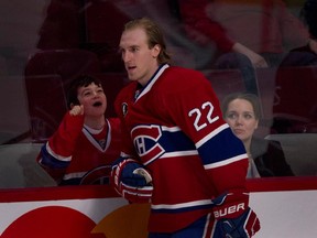 A young fan cheers after Canadiens' Dale Weise tapped on the glass and said hello during NHL action against the Detroit Red Wings at the Bell Centre in Montreal on Thursday April 9, 2015.