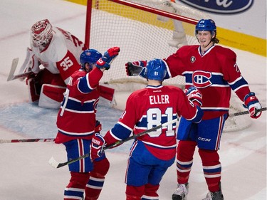 Montreal Canadiens centre Alex Galchenyuk, left, and Montreal Canadiens defenceman Jeff Petry, right, congratulate Montreal Canadiens centre Lars Eller after he scored the winning goal in overtime against Detroit Red Wings goalie Jimmy Howard at the Bell Centre in Montreal on Thursday April 9, 2015.