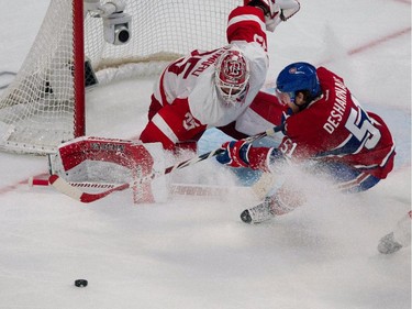 Montreal Canadiens centre David Desharnais fails to score against Detroit Red Wings goalie Jimmy Howard, left during NHL action at the Bell Centre in Montreal on Thursday April 9, 2015. The Canadiens went on to win in overtime allowing Cary Price to set a new team record with 43 regular season wins.