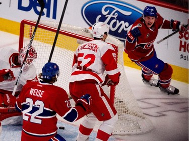 Montreal Canadiens defenceman Jeff Petry, right, celebrates after scoring against Detroit Red Wings goalie Jimmy Howard during NHL action at the Bell Centre in Montreal on Thursday April 9, 2015. Montreal Canadiens right wing Dale Weise and Detroit Red Wings defenceman Jonathan Ericsson look on.