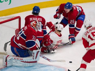 Montreal Canadiens defenceman Jeff Petry grimaces as Detroit Red Wings left wing Tomas Tatar falls on his stick after being hit by Montreal Canadiens defenceman Nathan Beaulieu to clear him from Montreal Canadiens goalie Carey Price's goal crease during NHL action at the Bell Centre in Montreal on Thursday April 9, 2015.