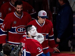 Montreal Canadiens goalie Carey Price looks up to the cheering crowd after being pied in the face by Montreal Canadiens defenceman Alexei Emelin at the Bell Centre in Montreal on Thursday ,April 9, 2015. Price set a new team record with 43 regular season wins after beating the Detroit Red Wings 4-3 in overtime.
