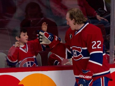 Montreal Canadiens right wing Dale Weise gestures to a young fan during the pre-game skate at the Bell Centre in Montreal on Thursday April 9, 2015.