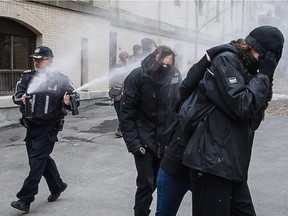 Protesters are pepper sprayed after attempting to march towards the Hubert-Aquin pavilion of UQAM in Montreal on Thursday, April 9, 2015. The group of student protesters had earlier successfully disrupted a class inside the  Judith-Jasmin building at UQAM.