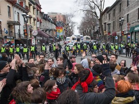 Student protesters chat in support of other protesters kettled by police on St-Denis street south of Sherbrooke in Montreal on Thursday, April 9, 2015. The protesters were demonstrating against what they see as the Quebec government's austerity policies as well as the arrests of protesters who were detained for disrupting classes at UQAM in violation of a court-ordered injunction.