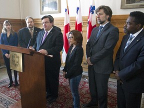 Montreal mayor Denis Coderre stands with Ensaf Haidar, third from right, wife of Raïf Badawi, blogger who has been flogged in Saudi Arabia, as he speaks during a press conference at Montreal city hall, Monday February 23, 2015.  The mayor announced that the city passed a motion calling for Raïf Badawi's freedom.  With them are other Montreal city councillors.