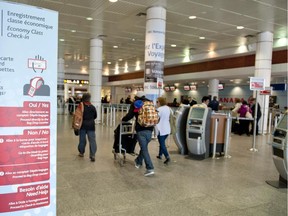 Passengers enter the check in area of Air Canada at Pierre Elliott Trudeau International airport in Montreal  Friday, April 13, 2012.