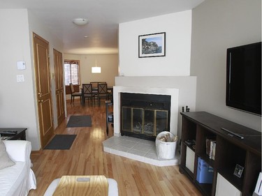 The bright living room has a wood-burning fireplace.