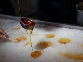 Canadian maple syrup taffy poured on the snow at Cabane a Sucre, Erabliere Au Sous-Bois in Mont St-Gregoire.