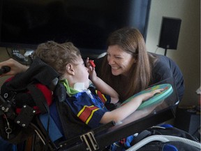 Kristen Roberts with her son James Rennie, 6, at their home in Île-Perrot,  Friday March 27, 2015. James, who requires life support 24 hours a day and is ventilator dependent, suffers from a disease called XMTM1.