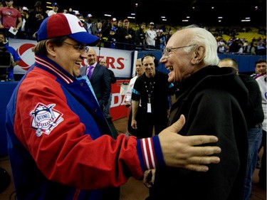 Montreal mayor Denis Coderre, left, greets baseball legend Jim Fanning beofe the start of a  preseason Major League Baseball game between the Blue Jays and the New York Mets at the Olympic Stadium in Montreal on Friday March 28, 2014.