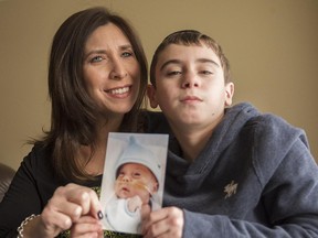 Rosaleen Rinzler with her son Josh Hutman, 10, holding a picture of Josh at 5 months,  at their home on Monday, March 30, 2015.