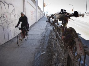 A cyclist uses the sidewalk at the St Denis street underpass at des Carrieres street, where a cyclist was killed last year in Montreal.