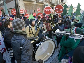 Protesters sing as they join hundreds of others in downtown Montreal, Saturday, November 15, 2014, in a protest against having pipelines from Alberta Tar Sands moving oil through Quebec.  The event was organized by a coalition of student groups.