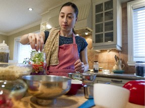 Shannon Leibgott prepares ingredients to assemble salads for a company she runs with her mother.