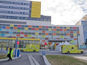 Ambulances pass in front of the MUHC Glen site, during a move of patients and equipment from the Royal Victoria Hospital, in Montreal, Sunday April 26, 2015.