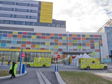 Ambulances pass in front of the MUHC Glen site, during a move of patients and equipment from the Royal Victoria Hospital, in Montreal, Sunday April 26, 2015.