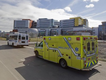 An ambulance and an adapted transport van arrive with patients at the MUHC Glen site, during a move of patients and equipment from the Royal Victoria Hospital, in Montreal, Sunday April 26, 2015.  The move of more than 200 patients to the new MUHC site is the biggest hospital move in Canadian history .