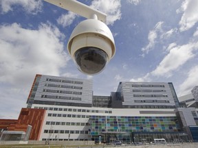 A security camera is suspended above the parking lot entrance at the MUCH Glen campus in Montreal, Tuesday April 28, 2015.  Security appears to be tight at the complex as journalists who didn't seek permission to enter the building have been refused access by hospital public relations staff, since the opening on Sunday.